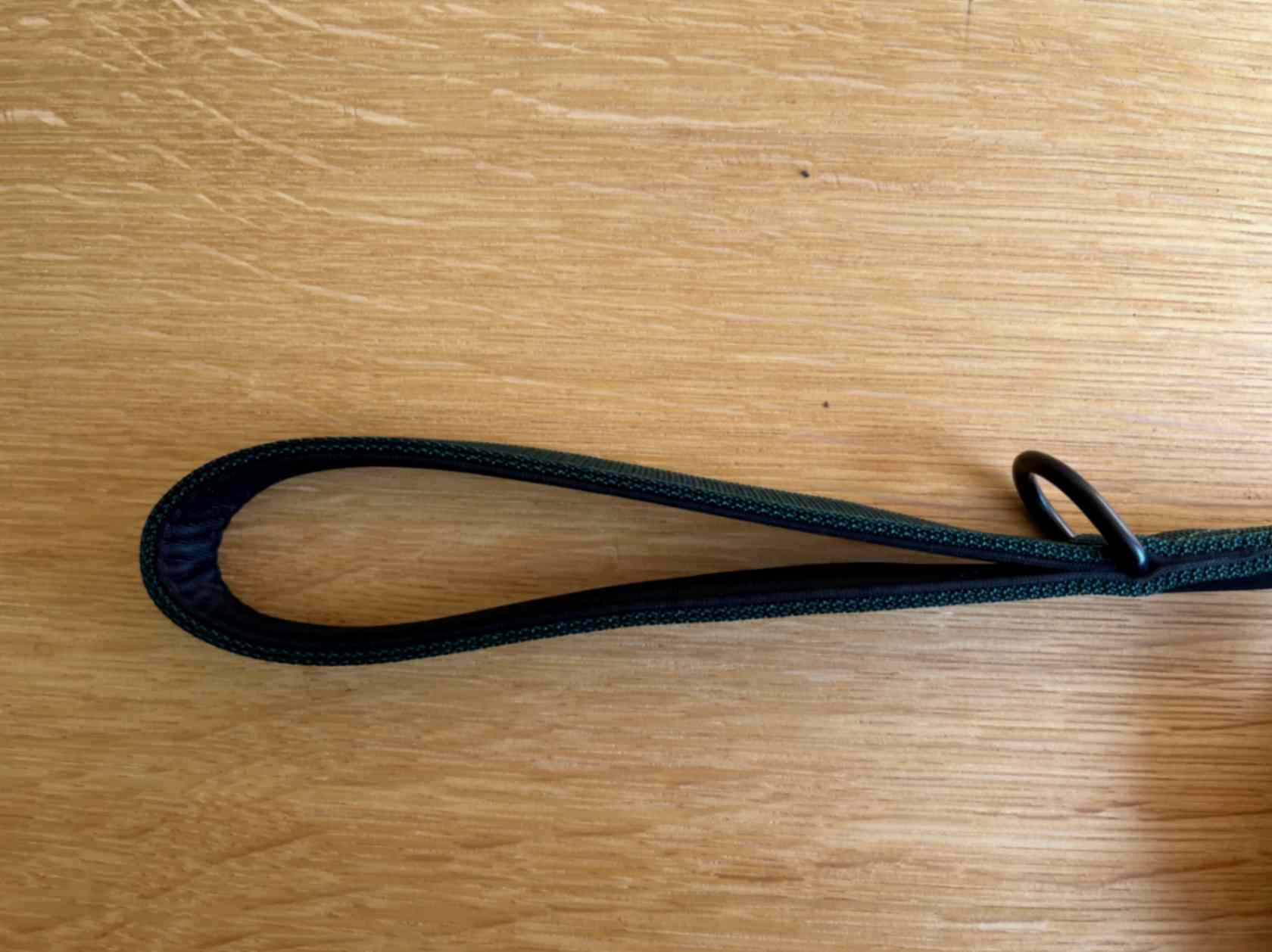 Handle of dark green dog leash