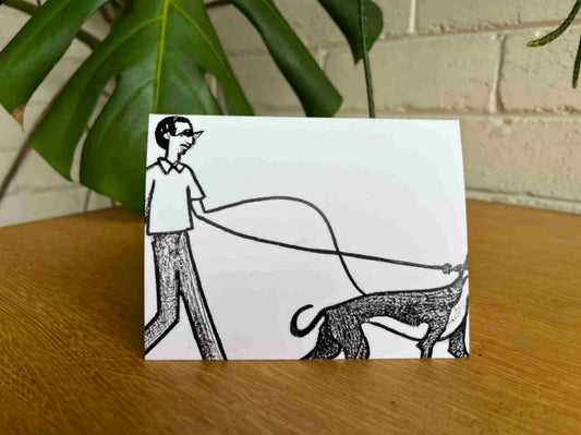 Greeting card of a dog walking with owner
